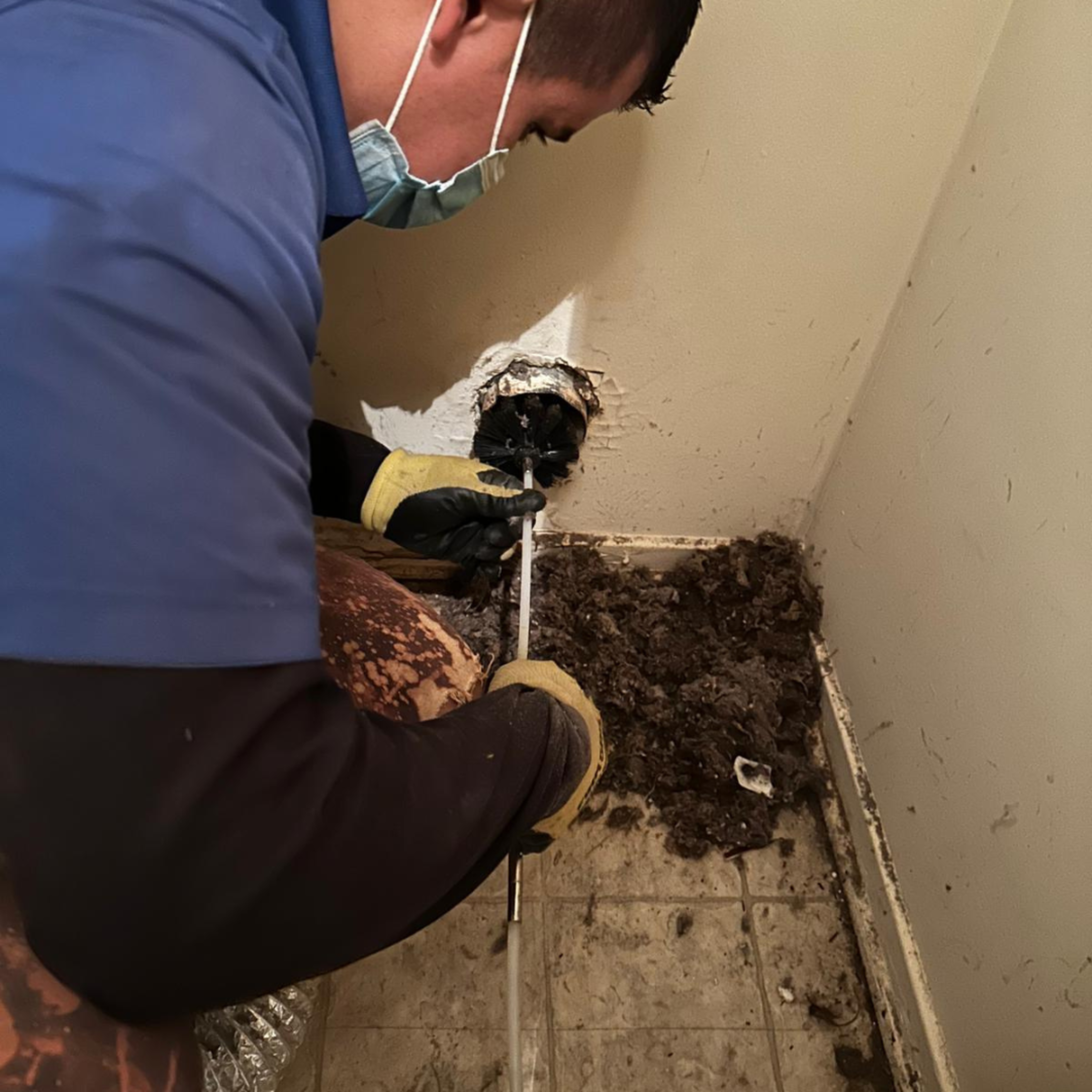 Close-up of a dryer vent being cleaned to improve airflow and reduce fire risk.