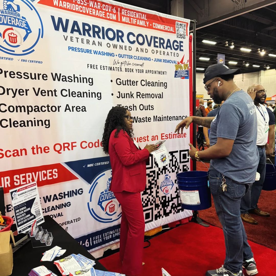 Monique Smith, Director of Warrior Coverage, assisting clients at a tradeshow booth, showcasing property maintenance and cleaning services.